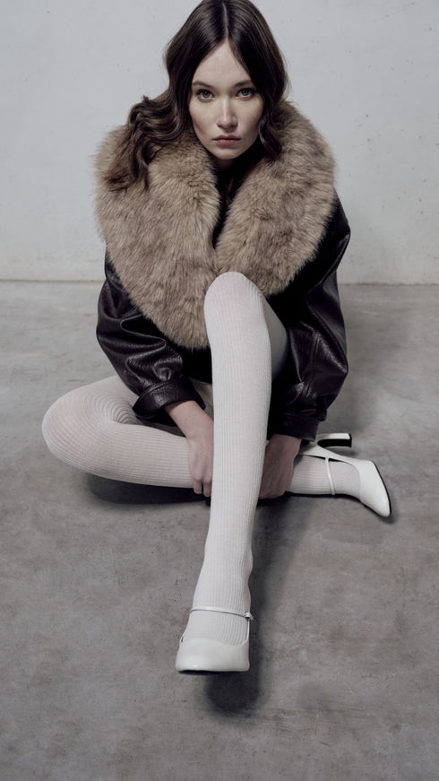 Cream ribbed wool tights styled with a fur-collared coat and white heels, Gibli Ribbed Wool Tights.
