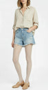 Person wearing a beige shirt, denim shorts, and white tights on a white background