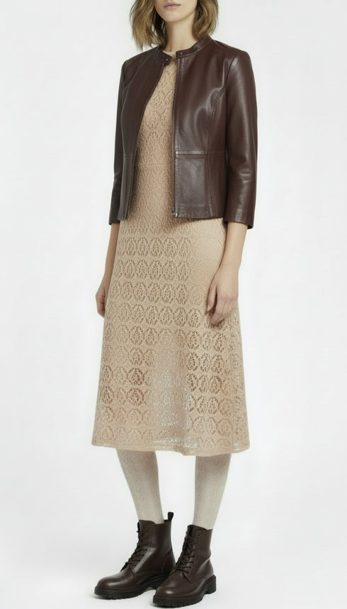 Beige lace dress worn by a person on a white background