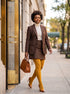 Model wears mustard tights with a brown suit, beige turtleneck, and matching heels, Classic Cotton Tights.
