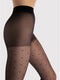 Black tights with dot pattern worn by a person on a light gray background
