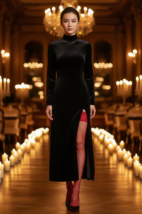 Woman in a black dress standing in an elegant room with candles and chandeliers.