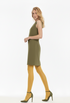 Woman wearing a green dress and mustard yellow tights on a white background