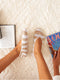 Ballerina ankle socks in a beige and white stripe pattern, viewed from above on a soft, textured rug.