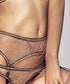Gold-plated suspender chain in Gold. Delicate chains draped over sheer lace lingerie.