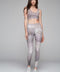 Palm leggings with a snake print pattern in gray and white, styled with a matching cropped top.