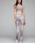 Palm leggings with a snake print pattern in gray and white, styled with a matching cropped top.
